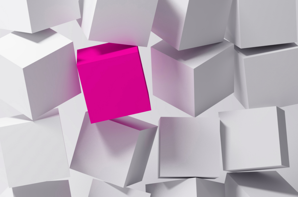 wall of stacked white cubes with one magenta cube standing out
