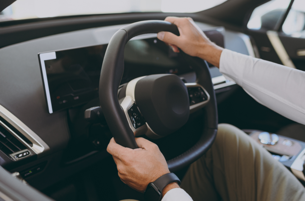 A person driving an electric vehicle