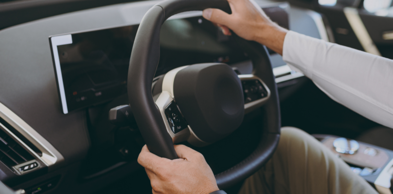 A person driving an electric vehicle