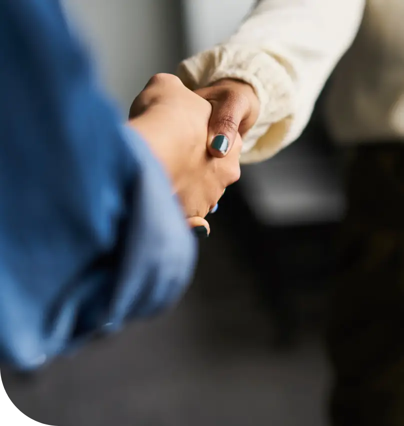 A closeup of a handshake between two business women
