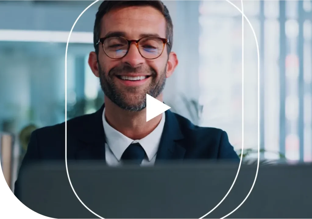 A video thumbnail with a play button of a man working in an office