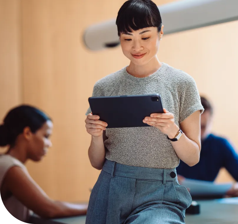 A woman views a tablet computer