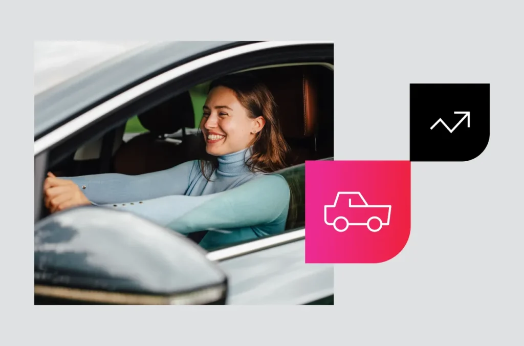 A smiling woman drives a car