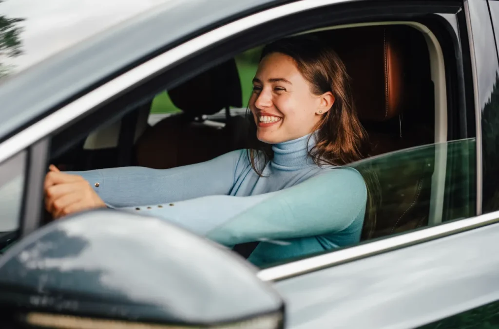 Woman driving her newly financed vehicle representing the shift in the indrect lending market and the importance of dealer partnerships.