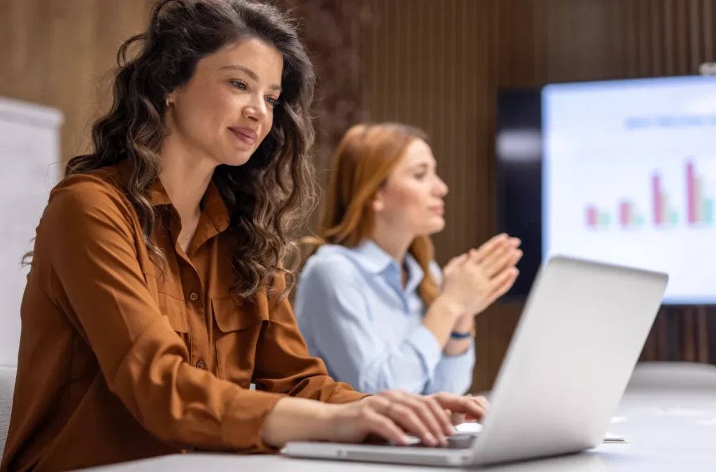 Credit union leaders working in its institution's loan origination system with a theme goal of achieving credit union growth.