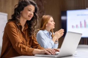 Credit union leaders working in its institution's loan origination system with a theme goal of achieving credit union growth.