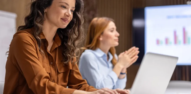 Credit union leaders working in its institution's loan origination system with a theme goal of achieving credit union growth.