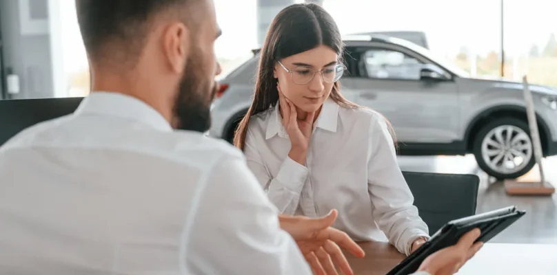 A customer reviewing their financing application with the finance manager representative indirect auto lending transformation.