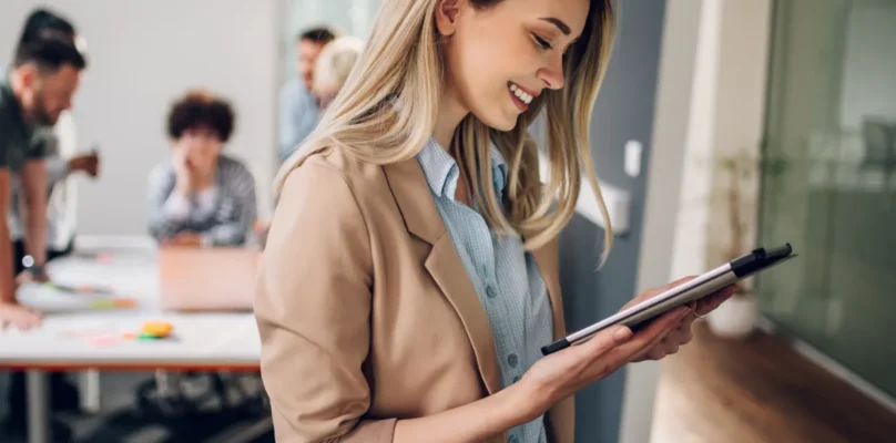 A credit union leader viewing the outsourcing performance metrics and how they measure up against the current lending environment on her tablet.