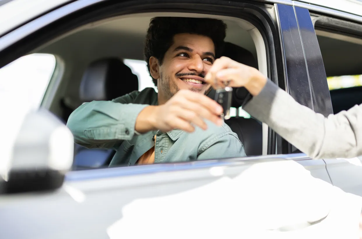 Customer receiving their keys to their pre-owned vehicle representing pre-owned market demand.