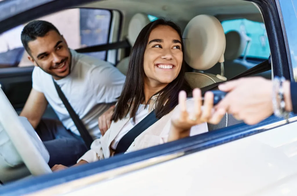 A couple receiving the keys to their newly purchased vehicle representing preferences of Gen Z borrowers.