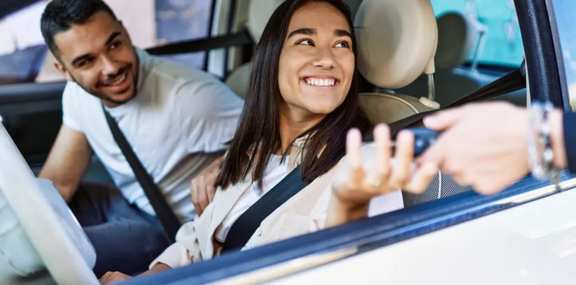 A couple receiving the keys to their newly purchased vehicle representing preferences of Gen Z borrowers.