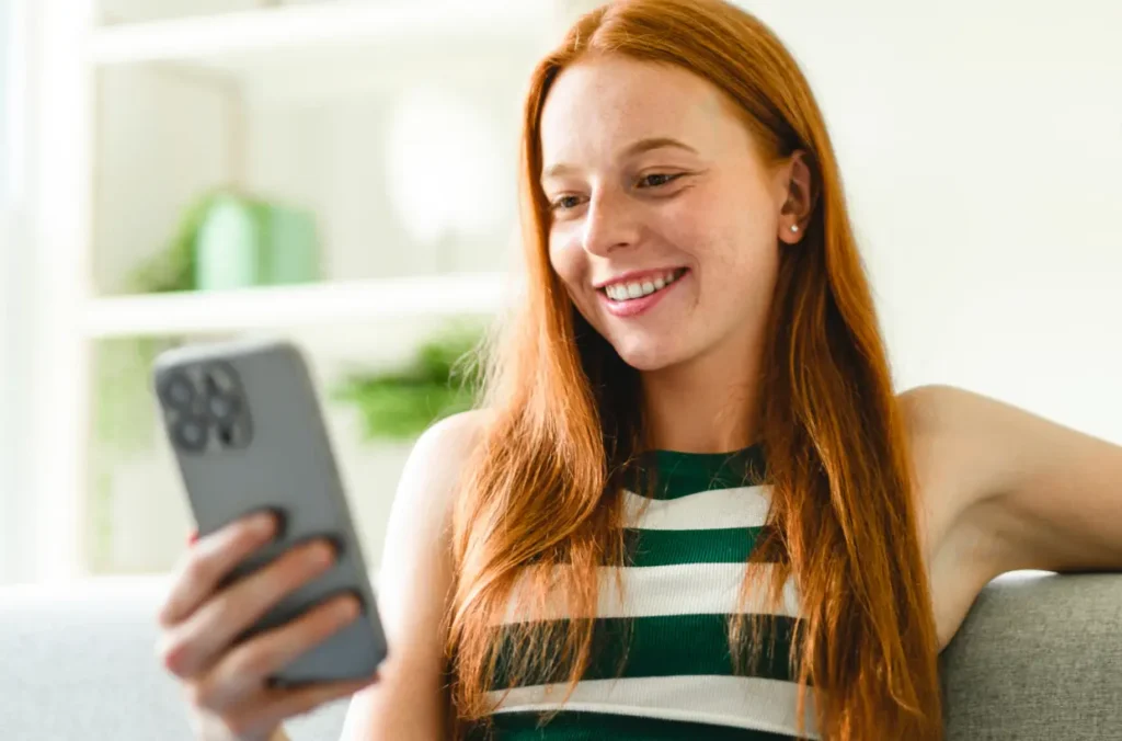 A credit union member viewing their digital application on the mobile device representing growth a credit union loan portfolio.